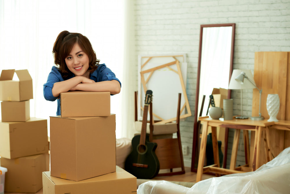 Lady posing on a stack of moving boxes