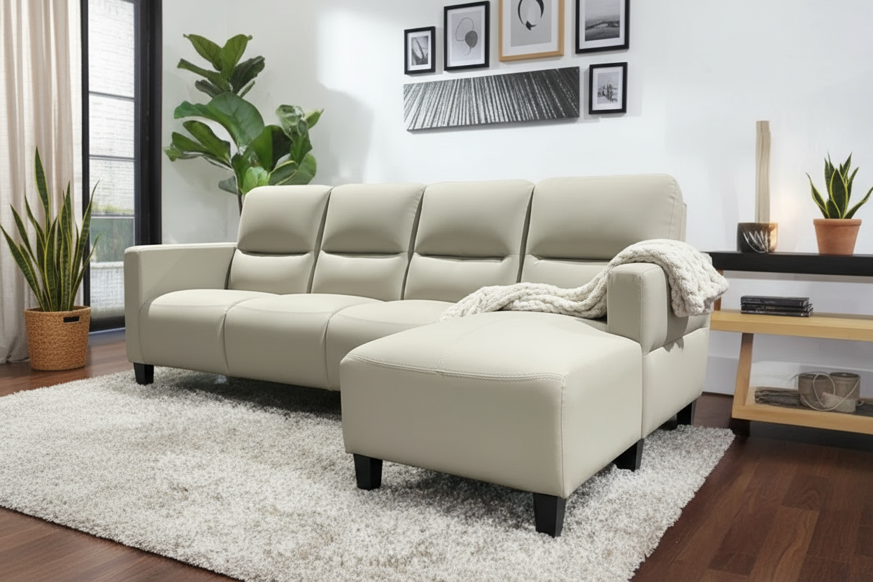 Beige sectional sofa in a living room setting with a white rug and window in the background.