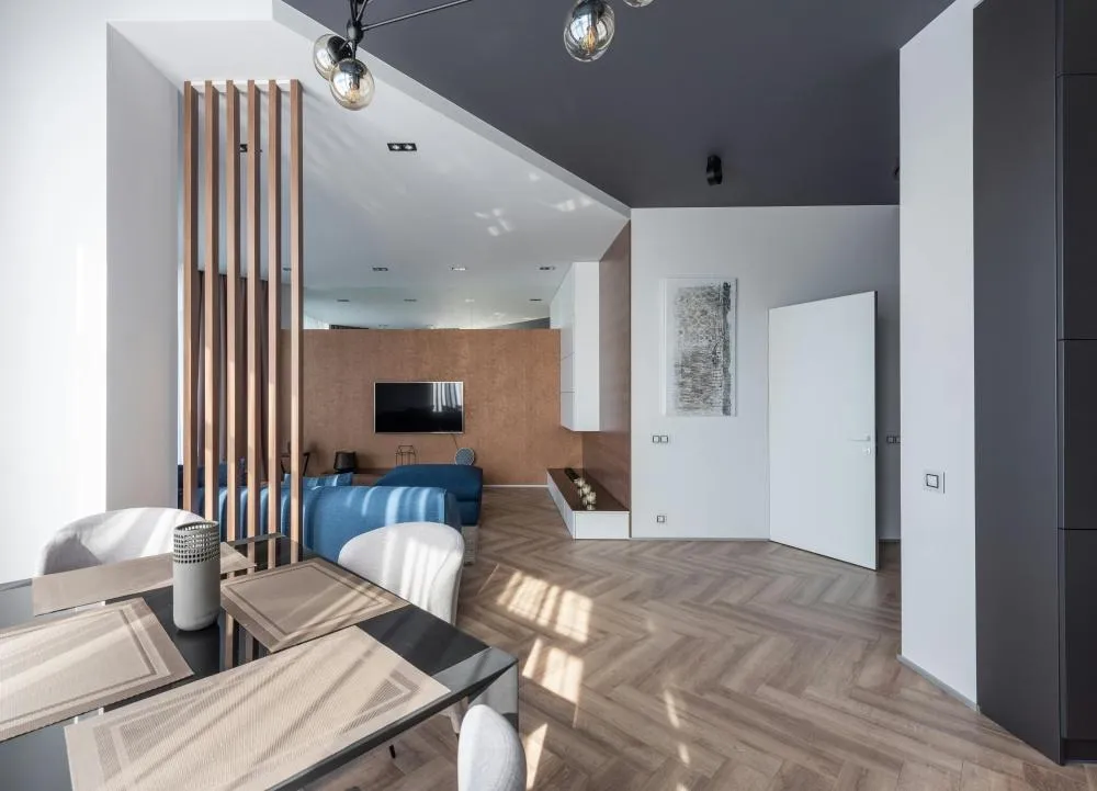 Modern open-concept HDB flat with kitchen, dining and living areas flowing into one spacious interior