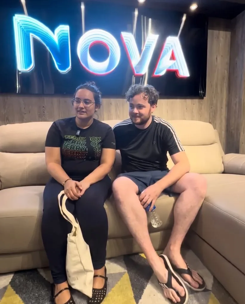 Two Nova Furnishing customers seated together in the showroom