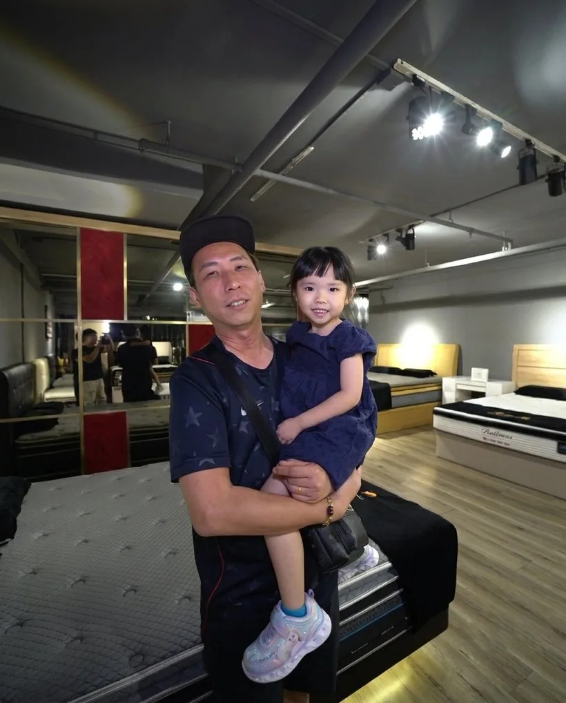 A Nova Furnishing customer with his child in the showroom